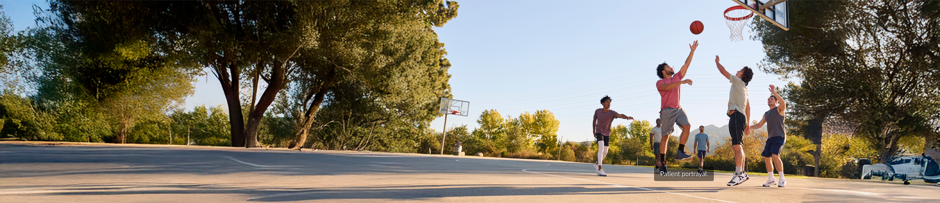 Men playing basketball in a park. Hypothetical patient.