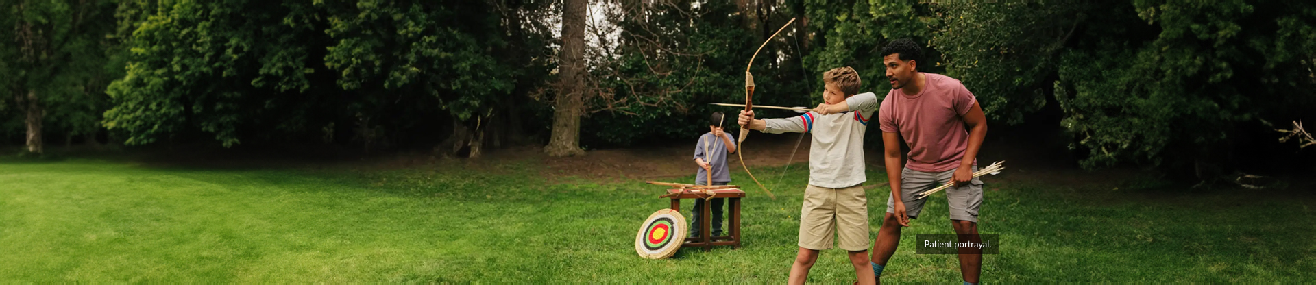 Child using a bow and arrow with an adult supervising. Hypothetical patient.