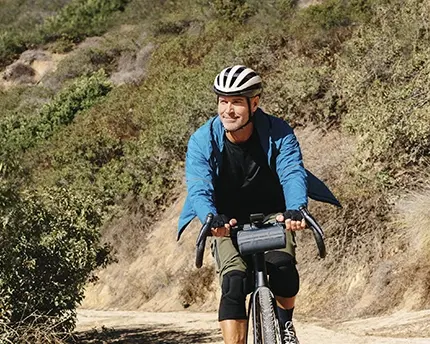 Cyclist riding down a mountain hill on his bicycle